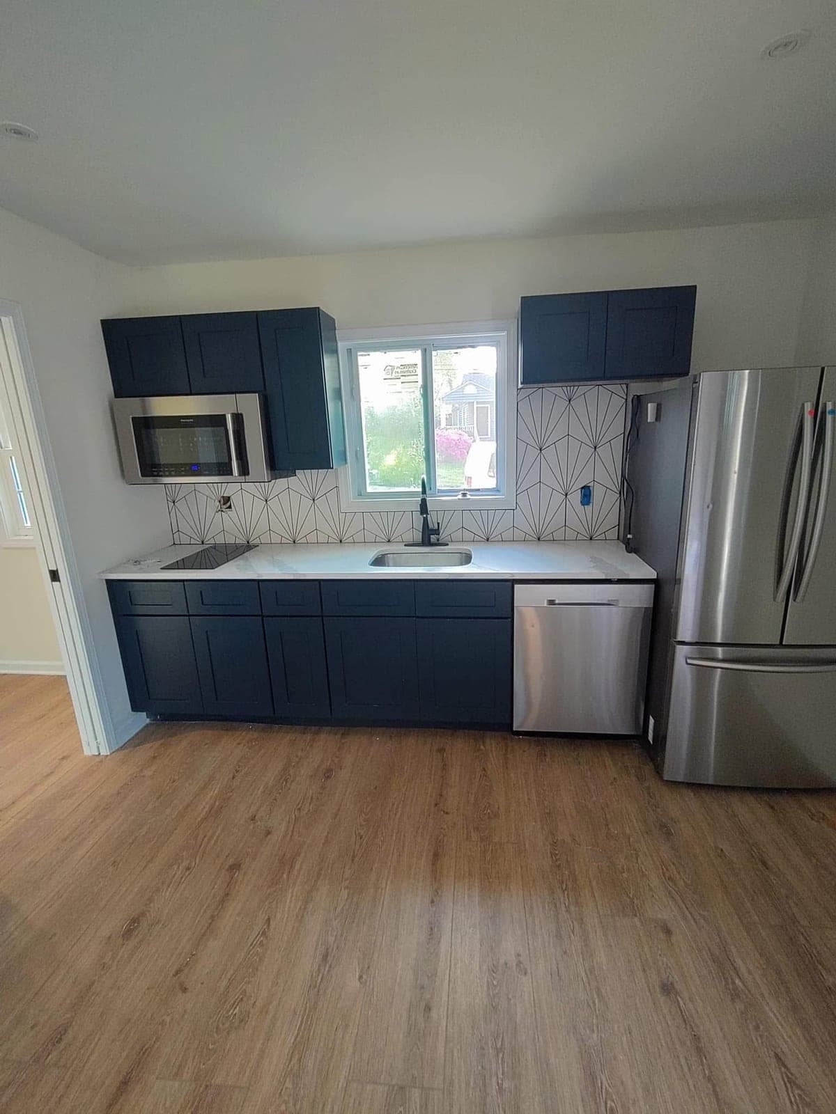 Kitchen with wood-look luxury vinyl plank flooring installed by Horizon Home Services